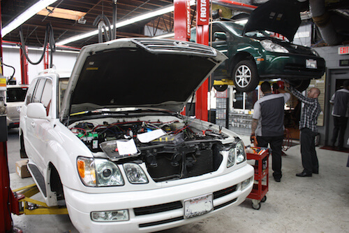 Several cars undergoing work at A+ Japanese Auto Repair in San Carlos, CA